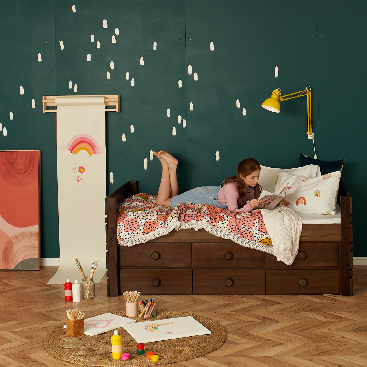 handy captain bed with large under bed storage drawers. With girl reading atop bed