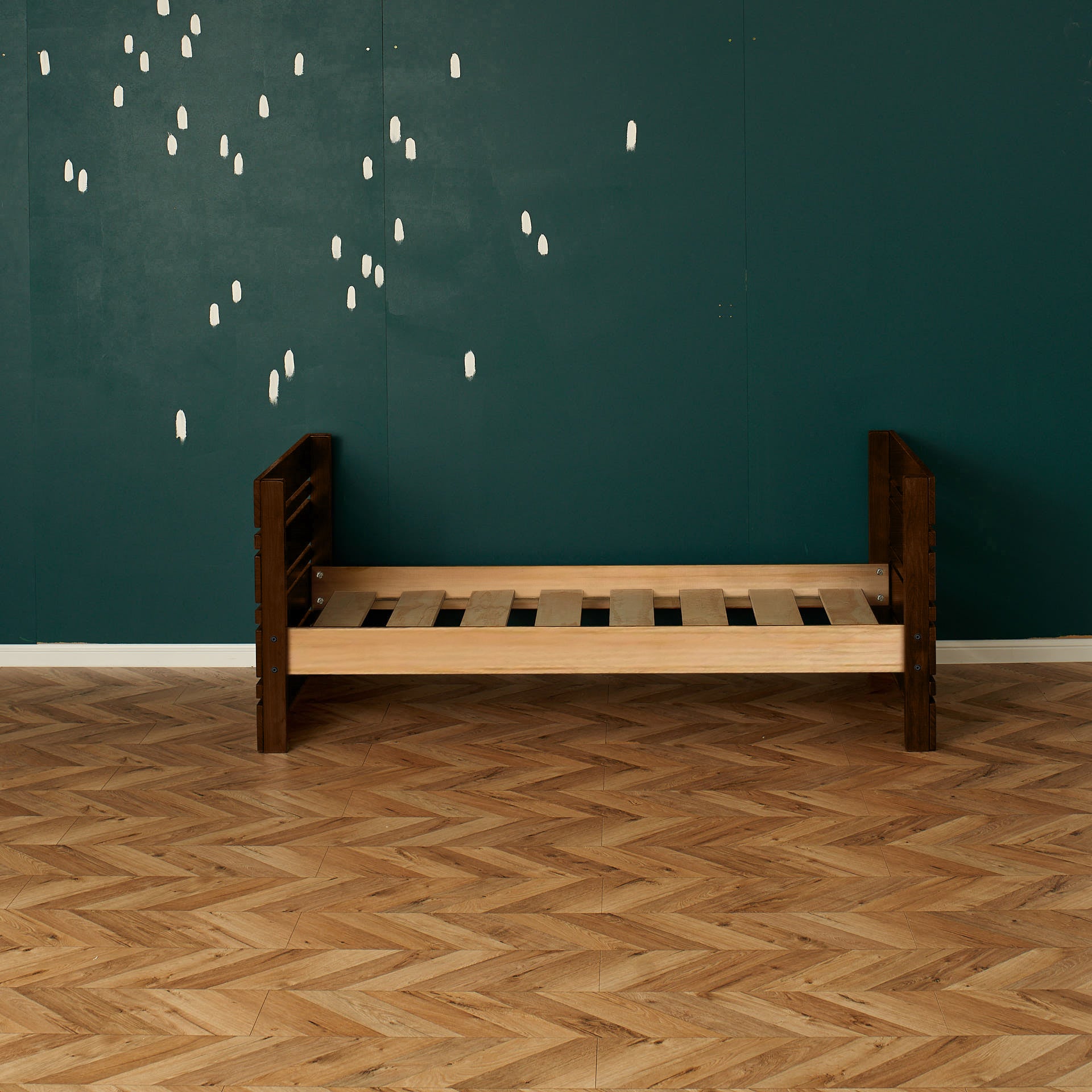 Dark native elm captains bed frame with slatted base and solid head and footboards on parquet floor.