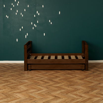 Dark wooden single captains bed frame with slatted base and guard rails against teal wall.