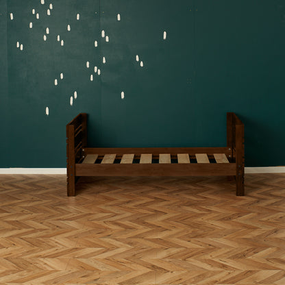 Native elm captains bed frame with slatted base and slatted headboard and footboard against teal wall.