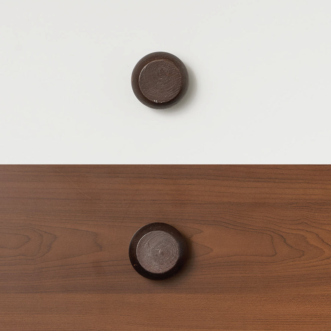 Round black timber handle mounted on wood panel, accessory for bunk bed or loft bed.
