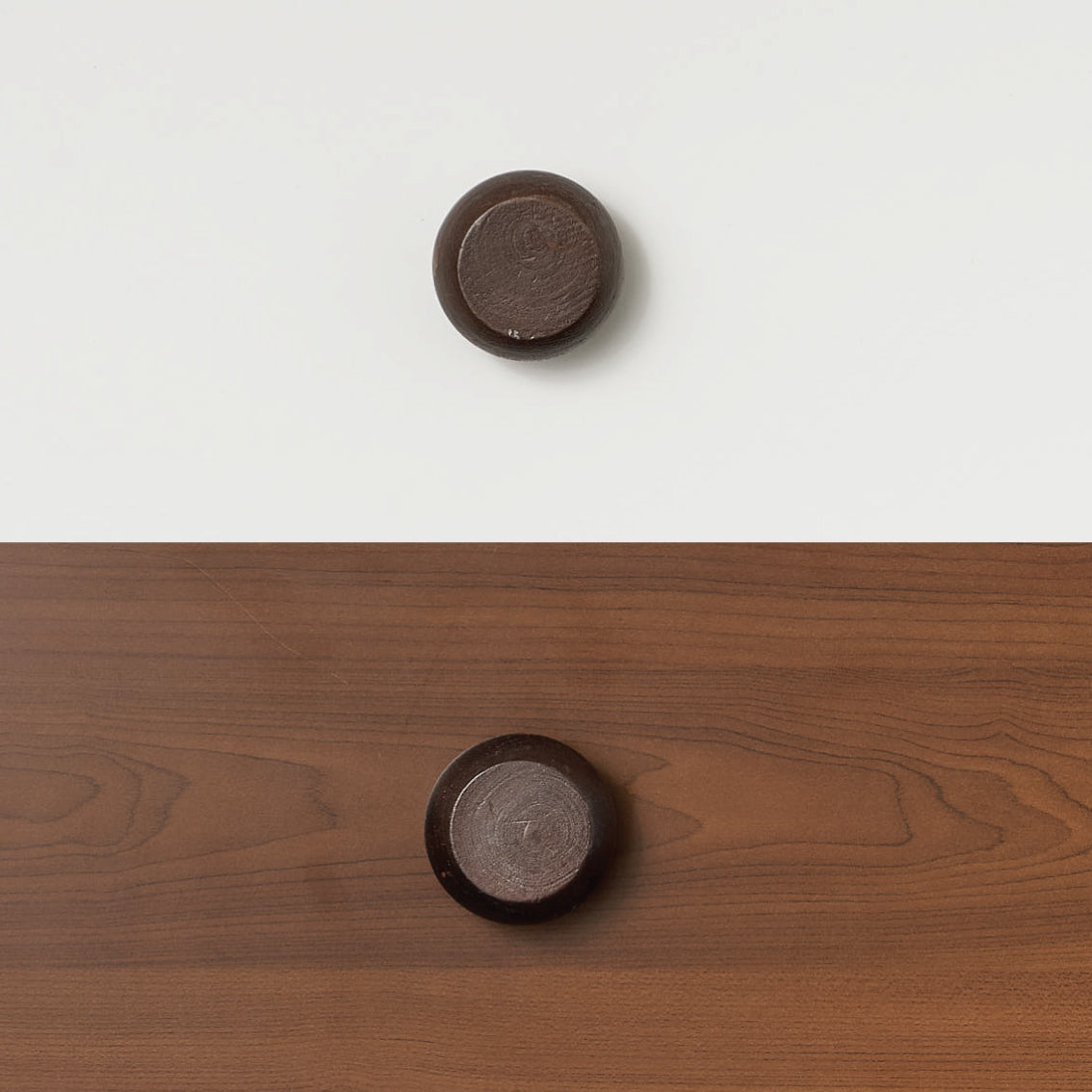 Round black timber handle mounted on wood panel, accessory for bunk bed or loft bed.