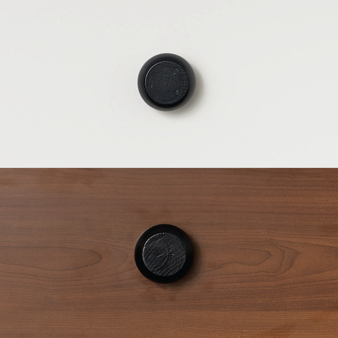 Black round handles on white and wood bunk bed or loft bed panels.