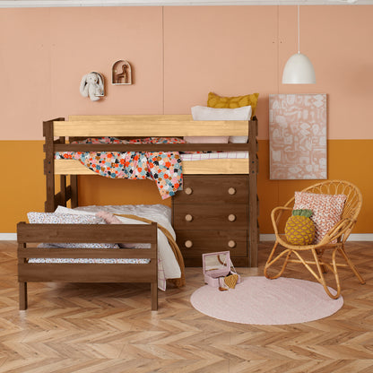 Low height corner bunk bed in dark wood with ladder and storage drawers, colorful bedding, cozy nursery setup.