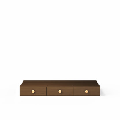 Low height high bed in dark wood with three built-in drawers and round wooden handles.