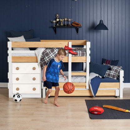 Low height long-wall bunk bed in white with natural elm accents, integrated chest drawers, and pull-out lower bed.