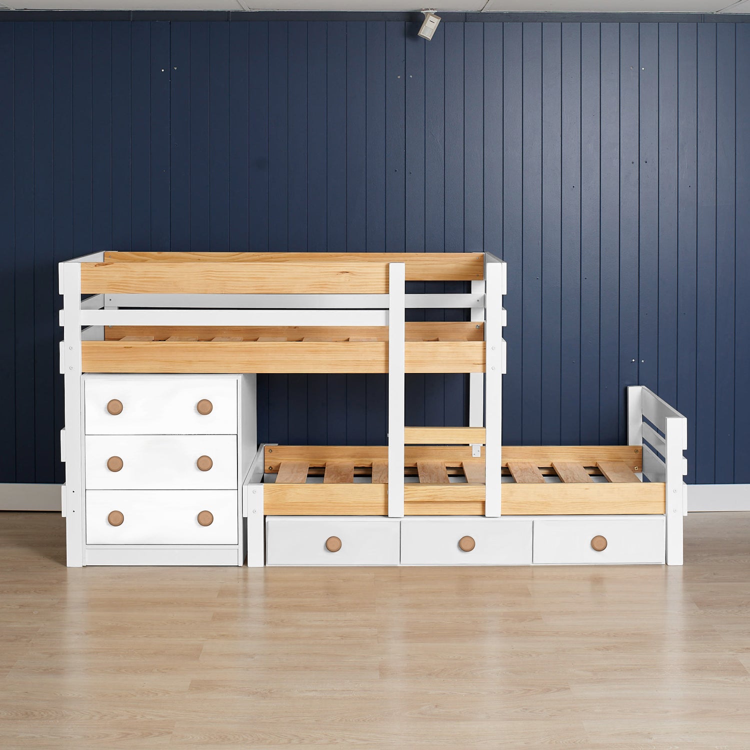 Low height long-wall bunk bed in white and native elm wood with built-in drawers and open slatted design.