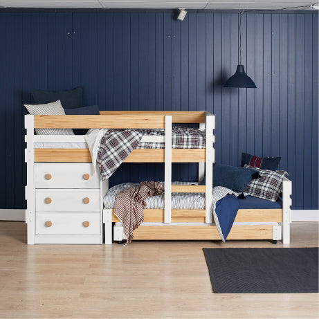 Low height long-wall bunk bed in elm and white with built-in drawers and stairs, styled with plaid bedding.