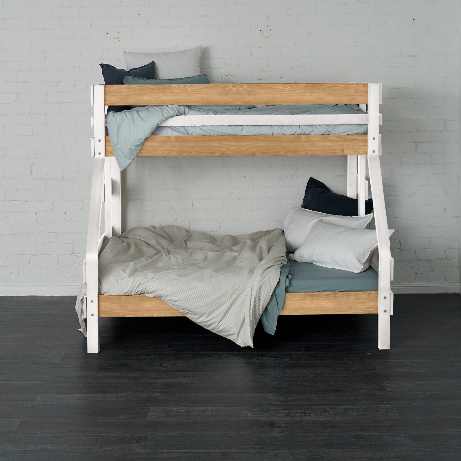 White and natural elm single over double bunk bed with angled ladder and cozy bedding.
