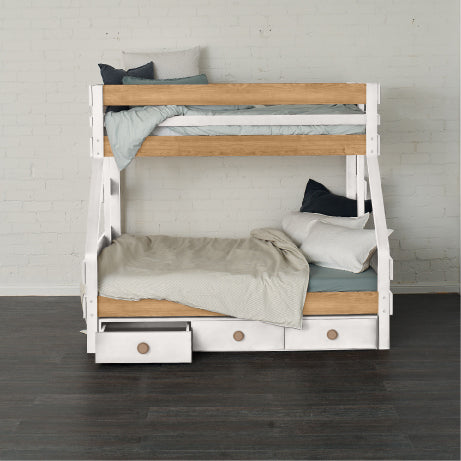 White and natural wood single over double bunk bed with under bed drawers and neutral bedding.