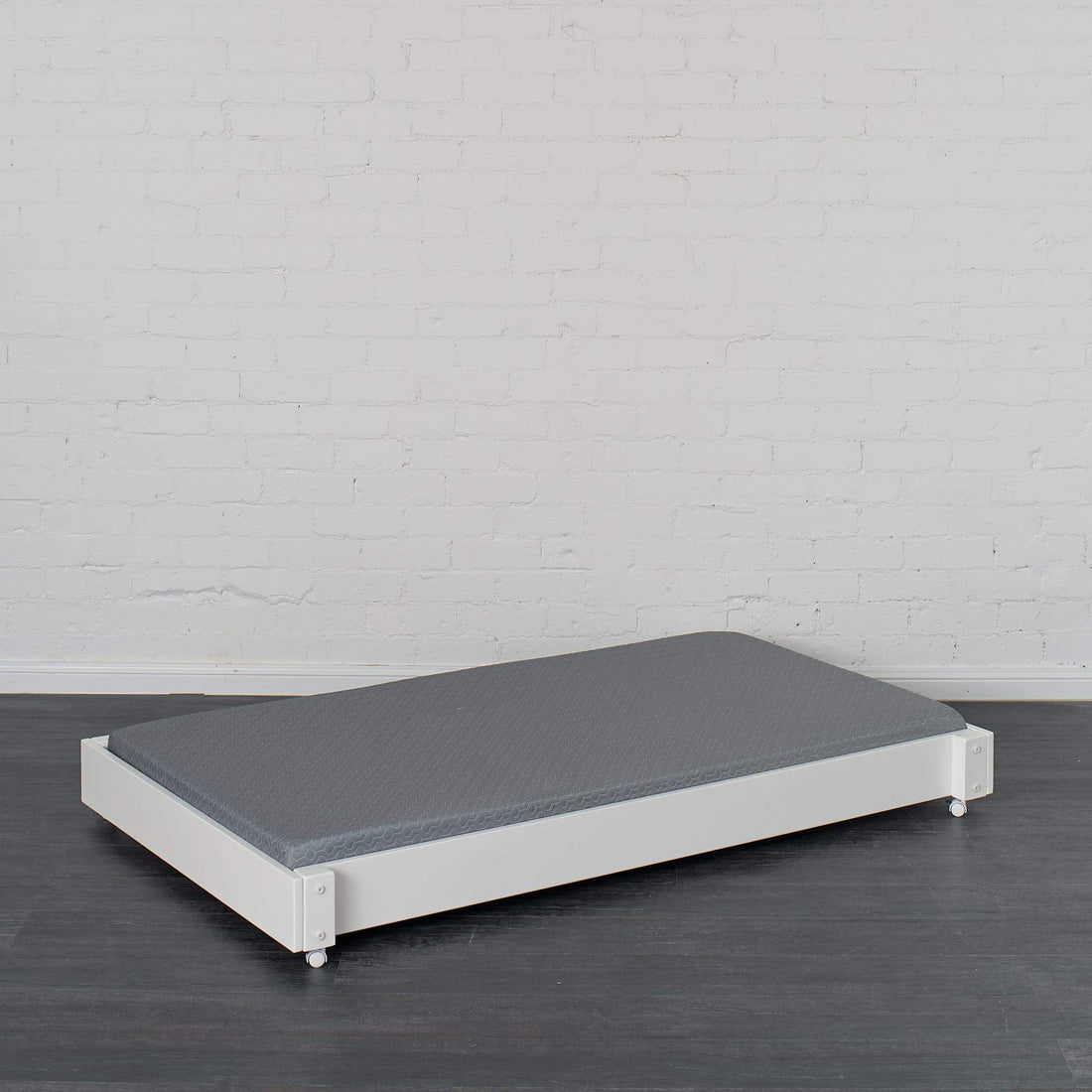 Trundle bed pictured in white finish with trundle mattress