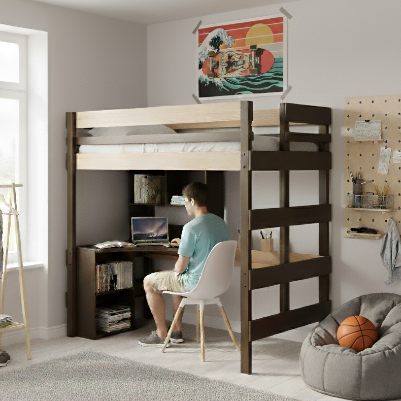 Teenager using a laptop at a desk under a loft bed in a room with a bean bag chair and wall art.