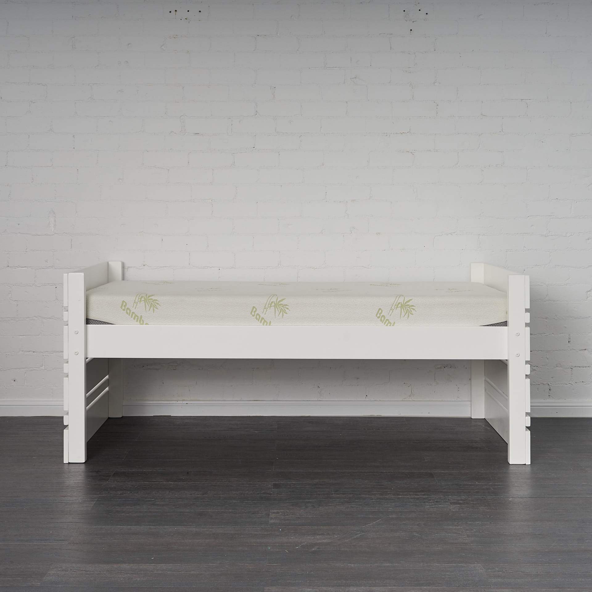 White Captain Bed pictured alone set at higher setting. Side view.