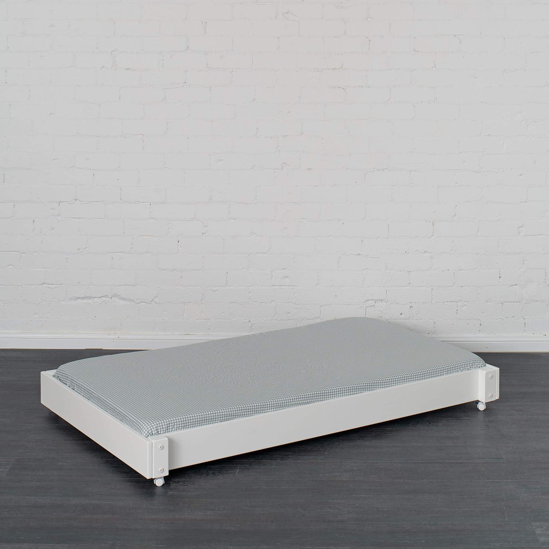 Trundle bed pictured in white finish with trundle mattress