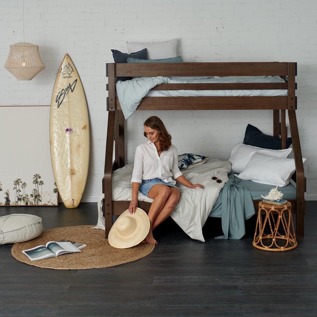 Holiday home with Adult relaxing on King Single over Queen bunk bed in native elm finish